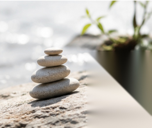 Balanced stones near calm water