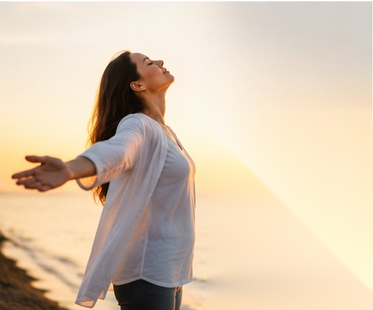 Woman opening her arms toward sunlight